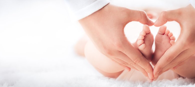 Mother Holding Baby's Feet In Heart Shaped Hands - Infant Care C Mother Holding Baby's Feet In Heart Shaped Hands - Infant Care C